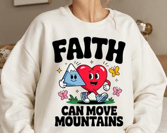 May include: White sweatshirt with a graphic design of a heart and a mountain with the text "FAITH CAN MOVE MOUNTAINS".