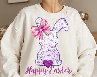 May include: White sweatshirt with a purple and pink bunny silhouette with a bow and the text "Happy Easter".