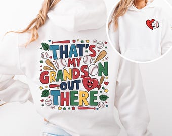 May include: White hoodie with a colorful graphic on the back that says "That's my grandson out there" with baseballs, bats, stars, and hearts. The front of the hoodie has a small heart with a baseball graphic.