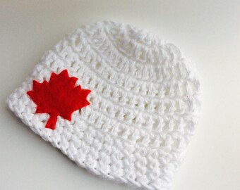 Cotton beanie with red maple leaf applique in white for newborn baby