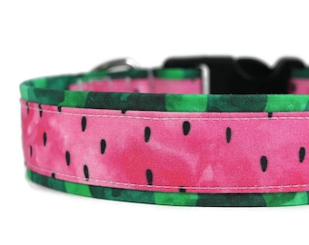 May include: A pink and green dog collar with a watermelon print. The collar has a black adjustable buckle.