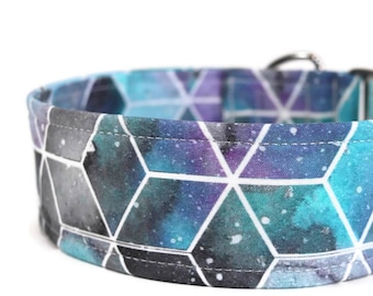 May include: A blue and purple dog collar with a geometric pattern and white accents. The collar has a silver buckle.