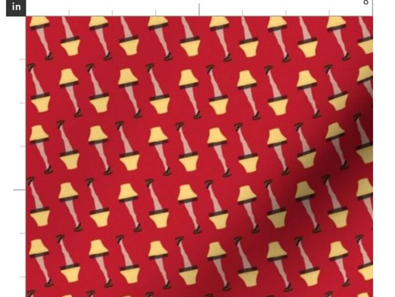 May include: A red fabric with a repeating pattern of yellow lampshades with legs and black shoes. The lampshades are in the shape of a traditional table lamp with a white lightbulb.