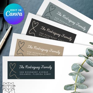 May include: A collection of address labels with the text "The Rodriguez Family" in a cursive font. The labels feature a heart-shaped design and are in various colors, including grey, black, and tan. The Canva logo is visible in the upper left corner.