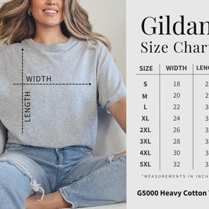 May include: A light gray Gildan G5000 heavy cotton tee shirt. The image includes a size chart with measurements in inches for sizes S through 5XL. The shirt is being modeled by a person wearing blue jeans.