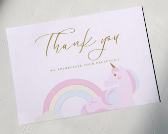 May include: A pink unicorn with a gold horn and a rainbow behind it. The text "Thank you" is written in gold script and the text "We appreciate your presence!!" is written in black below the unicorn.