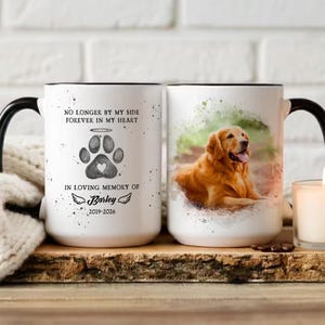 May include: White ceramic mug with a black handle and rim. One side features a paw print with a heart, angel halo, and the text "NO LONGER BY MY SIDE FOREVER IN MY HEART" and "IN LOVING MEMORY OF Barley 2019-2026". The other side has a watercolor image of a golden retriever.