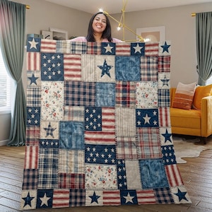 May include: A patchwork quilt featuring a repeating pattern of red, white, and blue squares. The design incorporates various textures including denim-look fabric, plaid, stripes, and floral prints, accented with multiple white star motifs.