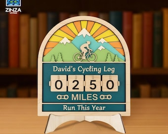 May include: A wooden arched cycling log display featuring a layered mountain and sun design, a cyclist silhouette, and four rotating number blocks showing 0250. The text reads David's Cycling Log, MILES, and Run This Year.