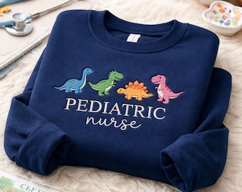 Sudadera con cuello redondo bordada con diseño de dinosaurio para enfermera pediátrica, ropa para personal médico de enfermería.