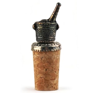May include: A decorative wine bottle stopper featuring a cork base and a detailed metal top. The metal top is shaped like a champagne bottle in an ice bucket. The stopper is designed to fit standard wine bottles.