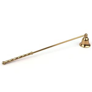 May include: A brass candle snuffer with a bell-shaped head and a long, slender handle. The handle has a decorative, textured design near the end. The snuffer is designed to extinguish candles safely and efficiently.