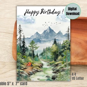 May include: A printable birthday card, approximately 12.7cm x 17.8cm, with a watercolour landscape. The card shows a mountain range, river, trees, and an orange tent. The words "Happy Birthday!" are at the top. It is a digital download.