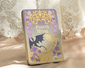 May include: A purple and gold book-style case with the words "Fourth Wing" and a dragon illustration. The case is decorated with purple flowers and gold accents. The name "Giselle" is written on the bottom right.