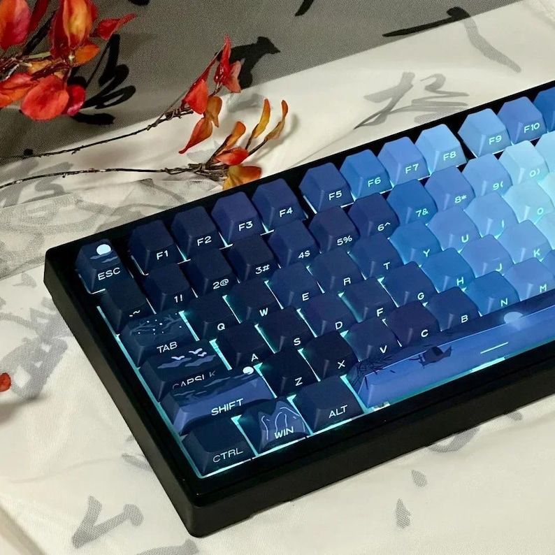 May include: A blue and black mechanical keyboard with a gradient color scheme. The keys have a variety of symbols and letters printed on them, including the letters ESC, F1, F2, F3, F4, F5, F6, F7, F8, F9, F10, TAB, Q, W, E, R, T, Y, U, I, O, P, A, S, D, F, G, H, J, K, L, Z, X, C, V, B, N, M, SHIFT, CTRL, WIN, and ALT. The keyboard has a black frame and a blue and black color scheme.