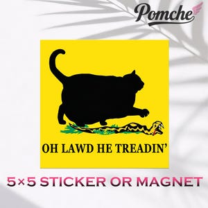 May include: A yellow square sticker or magnet featuring a black cat silhouette with the text "OH LAWD HE TREADIN'". The cat is positioned above a green and yellow snake. The sticker measures 5x5 inches.