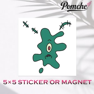 May include: A 5x5 sticker or magnet featuring a cartoonish, teal-colored blob with a single eye, a sad mouth, and stitched-on details. The Pomche logo is in the upper right corner.