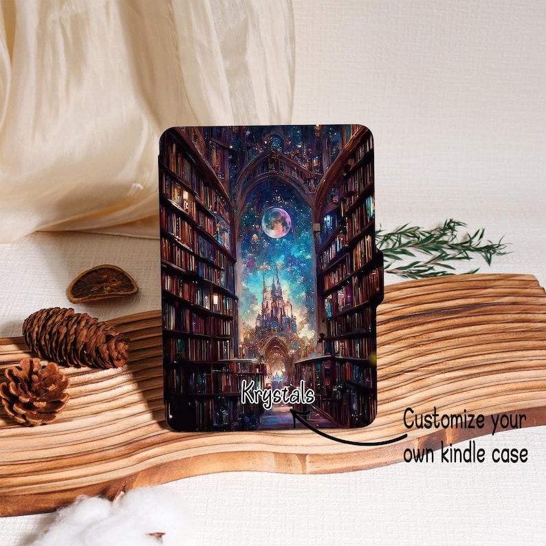 May include: A Kindle case featuring a fantasy library scene with a castle, moon, and starry sky. The case has a black magnetic closure. The text "Krystals" is visible, along with the phrase "Customize your own kindle case."