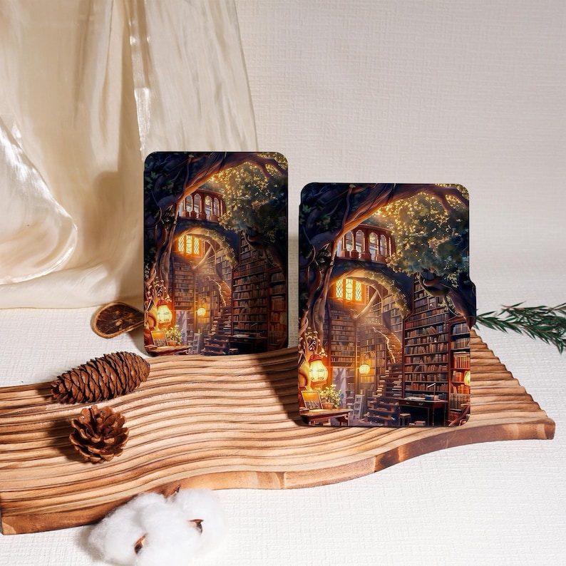 May include: Two rectangular art prints featuring a fantasy library scene with a staircase, bookshelves, and glowing lanterns. The prints have a warm color palette with shades of brown, yellow, and green. The prints are displayed on a wooden surface.