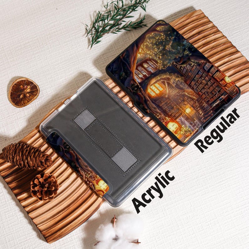 May include: Two tablet cases, one acrylic and one regular, are displayed on a wooden surface. The regular case features a detailed illustration of a building with warm lighting. The acrylic case is gray with a stand. The word "Acrylic" and "Regular" are printed on the cases.