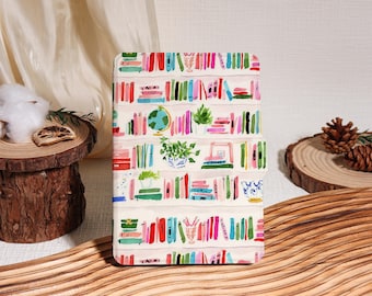 May include: A white case with a colorful bookshelf design. The design features rows of books in various colors, a globe, and potted plants. The case is rectangular and appears to be for a phone or tablet.