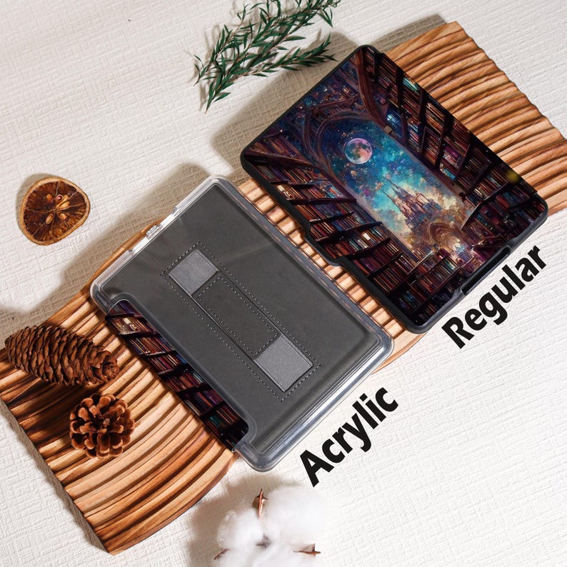 May include: Two tablet cases, one acrylic and one regular, are displayed. The regular case features a colorful fantasy scene of a library with a night sky and a castle. The acrylic case is clear with a gray interior and a stand.