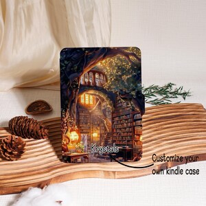 May include: A Kindle case featuring a detailed illustration of a library inside a tree, with warm lighting and bookshelves. The case has the text "Krystals" and "Customize your own kindle case".