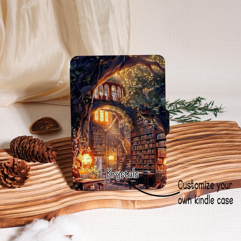 May include: A Kindle case featuring a detailed illustration of a library inside a tree, with warm lighting and bookshelves. The case has the text "Krystals" and "Customize your own kindle case".