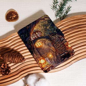 May include: A decorative item featuring a detailed illustration of a whimsical library built into a tree. The image showcases bookshelves, warm lighting, and a cozy reading nook. The item is placed on a wooden surface with decorative elements.