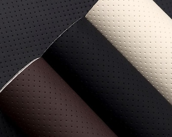 May include: Three rolls of perforated leather fabric in black, brown, and cream colors. The fabric has a textured, pebbled surface.