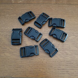 May include: Eight black plastic side release buckles. The buckles are approximately 2.5 cm in length.