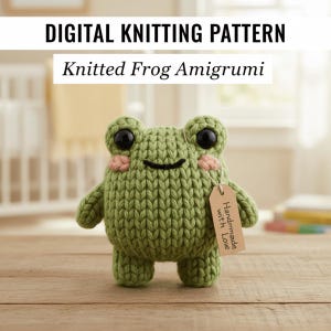 May include: A knitted green frog amigurumi with black eyes and pink cheeks. The frog has a tag that says "Handmade with Love". The image also includes the text "DIGITAL KNITTING PATTERN" and "Knitted Frog Amigurumi".