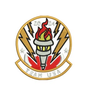 May include: Embroidered patch featuring a torch with red and yellow flames, the text "2024" and "TEAM USA". The patch has a gold border with gold lightning bolts and stars. The background includes a red and white design.