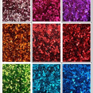 May include: Nine squares filled with sequins in various colours: silver, pink, purple, orange, red, green, teal, and blue. The sequins are small, round, and closely packed, creating a shimmering effect. A vibrant display of decorative elements.