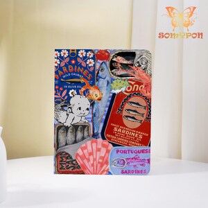 May include: A colorful collage featuring sardine cans and illustrations. The design includes a blue background with the word "Sardines" and a baby illustration. Other elements include fish, a seashell, and text in English and Portuguese.