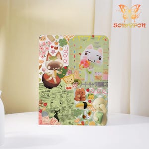 Pode incluir: Um caderno retangular colorido com personagens de desenhos animados e ilustrações. O design inclui um gato com flores, ursos e outros elementos fofos. O fundo tem um esquema de cores verde e branco com texto japonês.