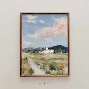 May include: A framed landscape painting featuring a white building with a red roof, set against a backdrop of rolling hills and a cloudy sky. The artwork is rendered in soft brushstrokes, with a color palette of blues, greens, and pinks. The artist's name, LUNA ELLIS, is at the bottom.