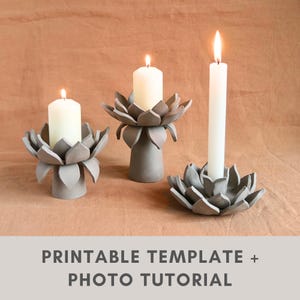 May include: Three gray ceramic lotus flower candle holders with lit white candles. The candle holders have a detailed petal design. The image includes the text "PRINTABLE TEMPLATE + PHOTO TUTORIAL".