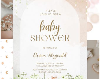 May include: Baby shower invitation with a watercolor design. The invitation features the words "baby shower" in elegant script, along with event details and a watercolor illustration of a deer in a field. The color palette includes soft pinks, greens, and gold.