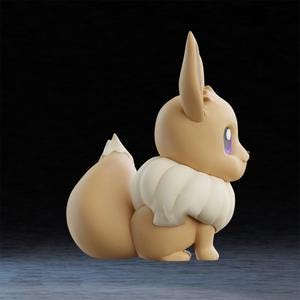 May include: A side view of a tan-colored Eevee figurine with a fluffy, cream-colored ruff and tail. The figurine has large, pointed ears and purple eyes. The background is a dark, gradient blue.