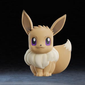 May include: A tan Eevee figurine with large ears, a fluffy white collar, and a white-tipped tail. The figurine has purple eyes and is posed in a sitting position. The background is dark.
