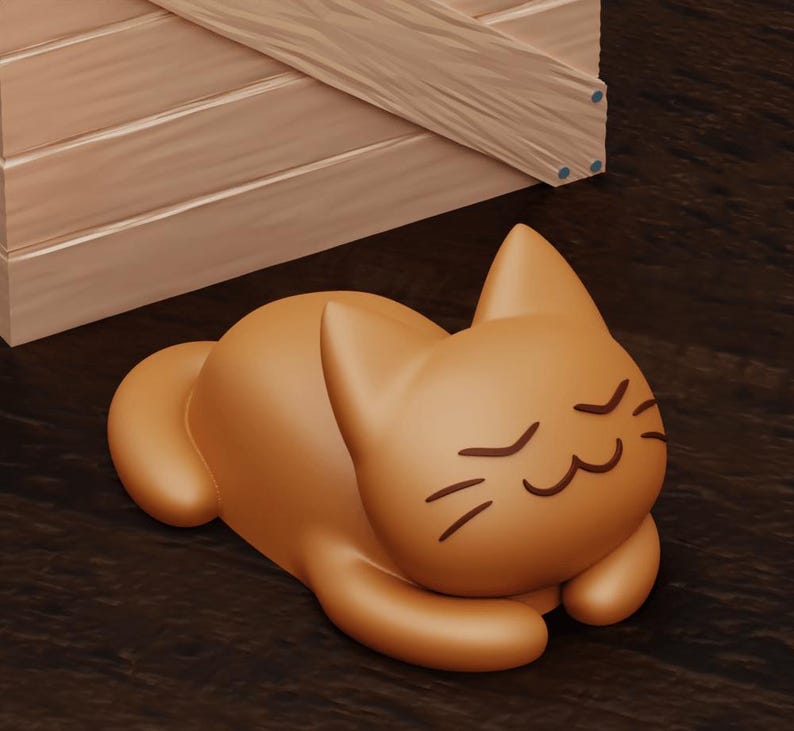 May include: A brown, cartoon-style cat figurine with closed eyes and a smiling expression. The cat is lying on its side with its paws tucked under its body.