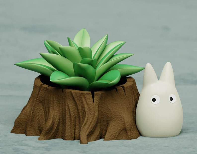 May include: A small, white, cartoon character with large eyes sits next to a brown tree stump planter with a green succulent plant.