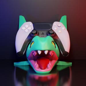 May include: A teal and pink dragon-themed gaming controller stand. The stand features a detailed dragon head design with a wide open mouth and a controller resting on top. The controller has white and black accents.