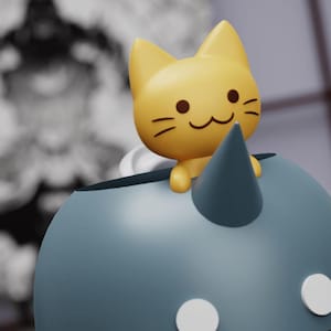 May include: A blue ceramic unicorn figurine with a yellow cat figurine sitting on its horn. The cat has a smiling face and brown eyes.