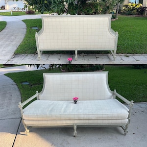 May include: A two-piece set of a light gray loveseat with a checkered pattern. The loveseat has a curved back and armrests. The cushions and back are a light cream color. The set is placed on a concrete surface with green grass in the background.