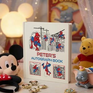 May include: A white hardcover autograph book featuring red and blue Spider-Man illustrations and the text "PETER'S AUTOGRAPH BOOK" in red and blue lettering. The book is surrounded by various character-themed plush toys and small metal pins.