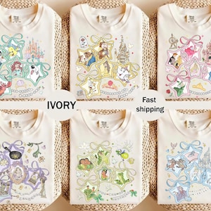 May include: Ivory-colored t-shirts with various cartoon character designs. Each shirt features a different design, including characters from popular animated movies. The text "IVORY" and "Fast shipping" are also visible.
