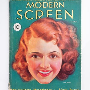 Könnte beinhalten: Ein Vintage-Magazin Modern Screen vom März mit einem Porträt von Janet Gaynor auf türkisfarbenem Hintergrund. Der Titeltext lautet The Finest Intimate Pictures of Your Hollywood Favorites, 10 cents und Hollywood Heartbreak von Vicki Baum.