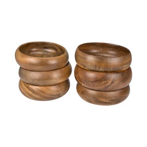 May include: Two stacks of wooden bowls. Each stack has three bowls. The bowls are a medium brown color with visible wood grain. The bowls are round with a slightly curved shape.